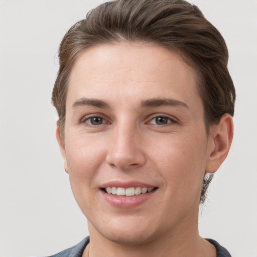 Joyful white young-adult female with short  brown hair and grey eyes