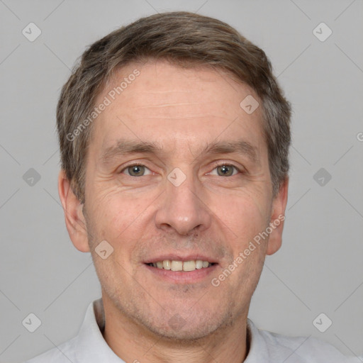 Joyful white adult male with short  brown hair and brown eyes