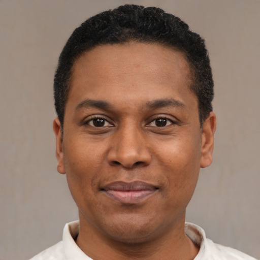 Joyful latino adult male with short  black hair and brown eyes