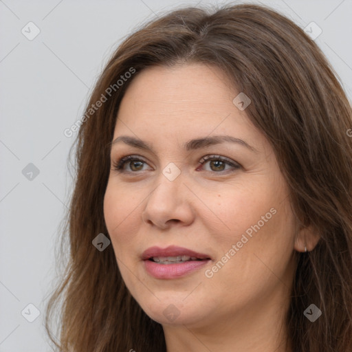 Joyful white adult female with long  brown hair and brown eyes