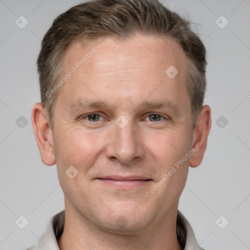 Joyful white adult male with short  brown hair and grey eyes