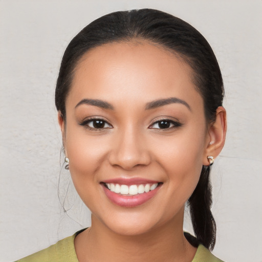 Joyful latino young-adult female with medium  black hair and brown eyes