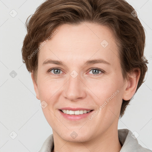 Joyful white adult female with short  brown hair and grey eyes