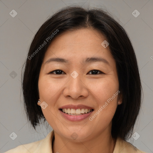 Joyful asian adult female with medium  brown hair and brown eyes