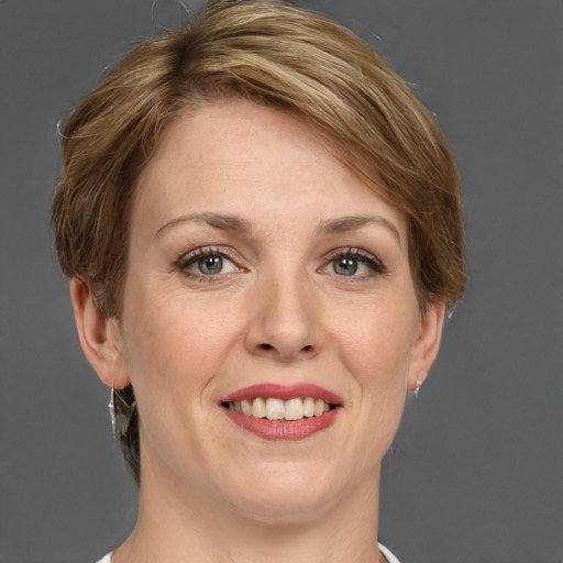 Joyful white adult female with medium  brown hair and grey eyes