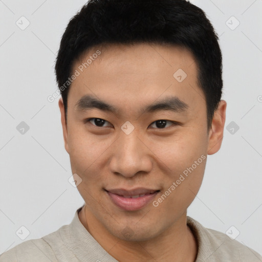 Joyful asian young-adult male with short  black hair and brown eyes