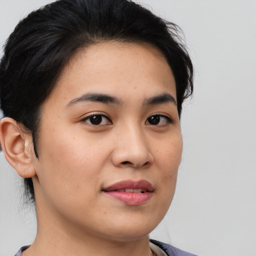 Joyful asian young-adult female with short  brown hair and brown eyes
