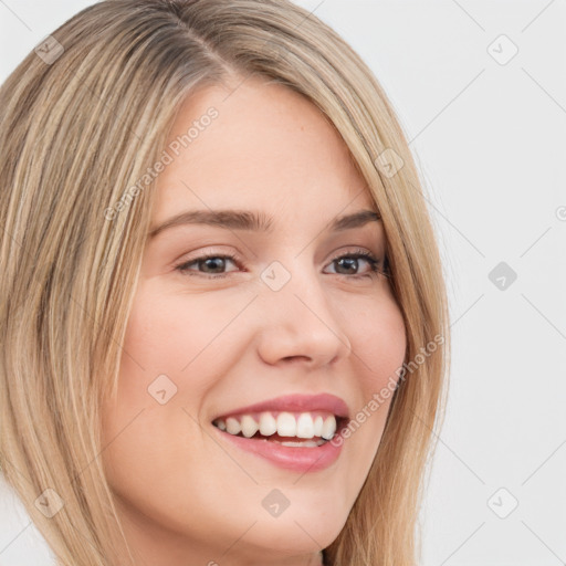 Joyful white young-adult female with long  brown hair and green eyes