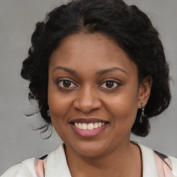 Joyful black young-adult female with medium  brown hair and brown eyes