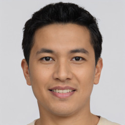 Joyful asian young-adult male with short  black hair and brown eyes