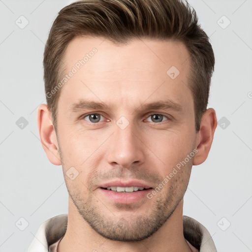 Joyful white young-adult male with short  brown hair and grey eyes