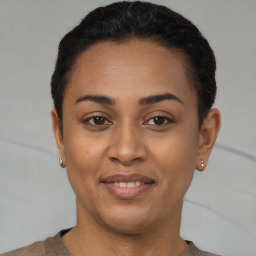 Joyful latino young-adult female with short  black hair and brown eyes