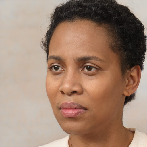 Joyful black young-adult female with short  brown hair and brown eyes