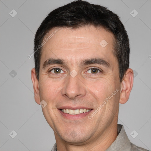 Joyful white adult male with short  brown hair and brown eyes