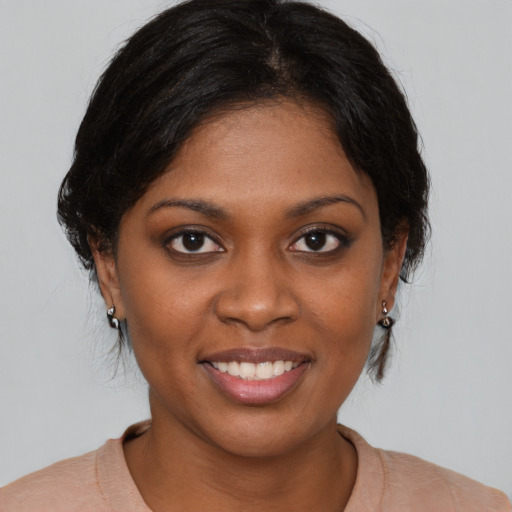Joyful black young-adult female with medium  brown hair and brown eyes