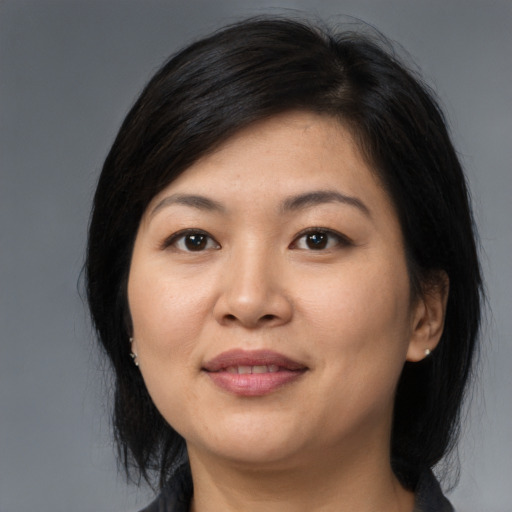 Joyful asian young-adult female with medium  black hair and brown eyes