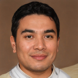 Joyful latino young-adult male with short  black hair and brown eyes