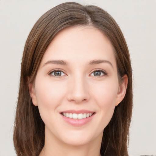 Joyful white young-adult female with long  brown hair and grey eyes