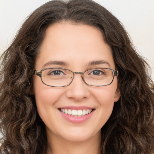 Joyful white young-adult female with long  brown hair and green eyes