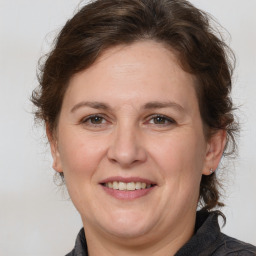 Joyful white adult female with medium  brown hair and brown eyes