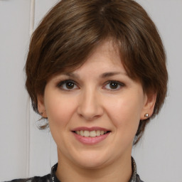 Joyful white young-adult female with medium  brown hair and brown eyes