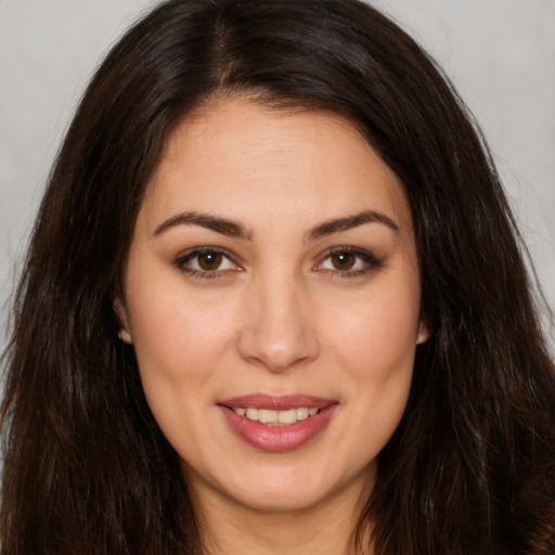 Joyful white young-adult female with long  brown hair and brown eyes