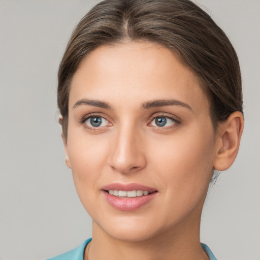 Joyful white young-adult female with short  brown hair and grey eyes