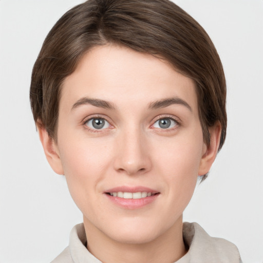 Joyful white young-adult female with short  brown hair and grey eyes