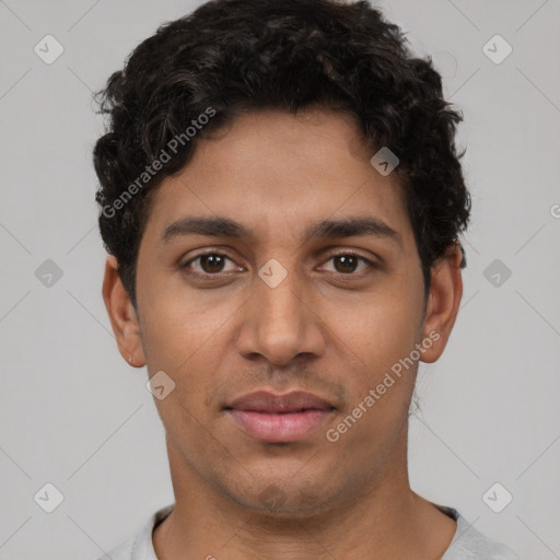 Joyful latino young-adult male with short  brown hair and brown eyes