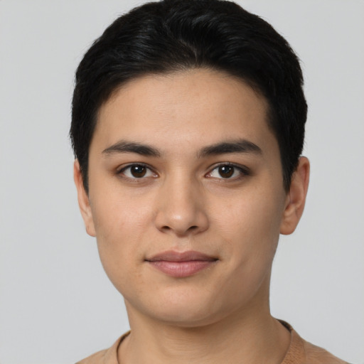 Joyful latino young-adult male with short  black hair and brown eyes