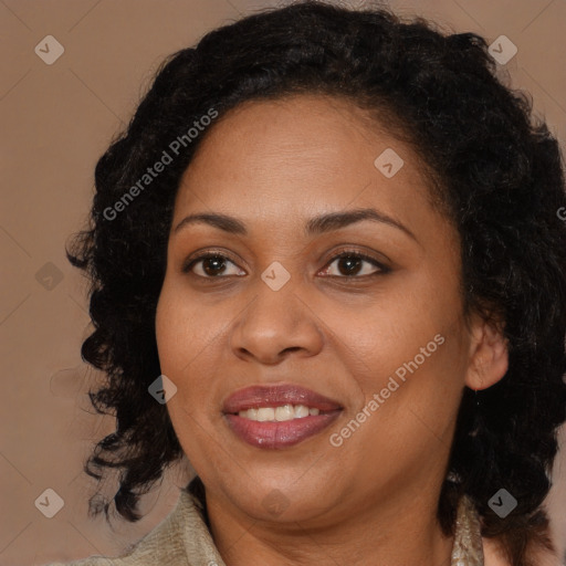 Joyful black adult female with long  brown hair and brown eyes