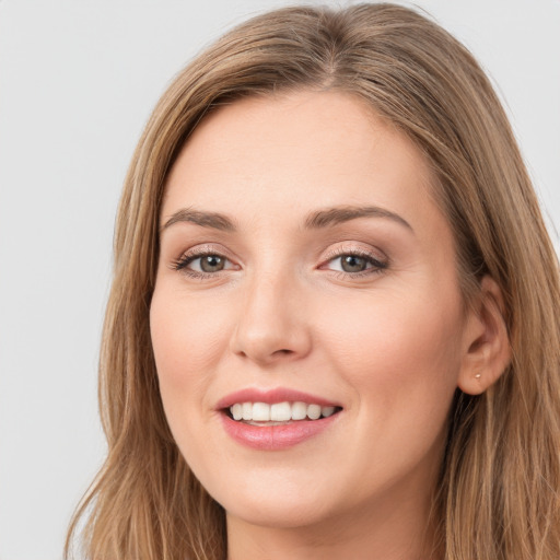 Joyful white young-adult female with long  brown hair and grey eyes