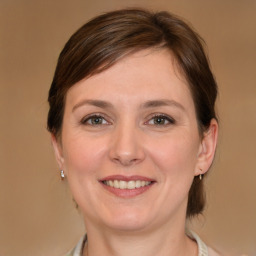 Joyful white young-adult female with medium  brown hair and grey eyes