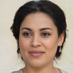 Joyful latino young-adult female with medium  brown hair and brown eyes