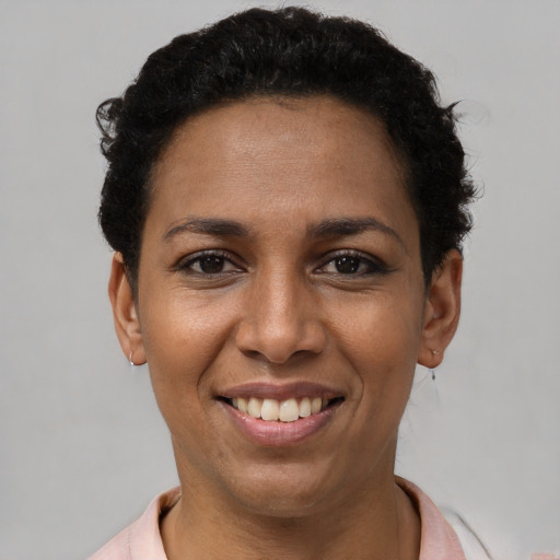 Joyful latino young-adult female with short  brown hair and brown eyes