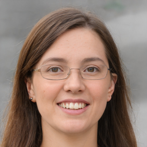 Joyful white young-adult female with long  brown hair and grey eyes