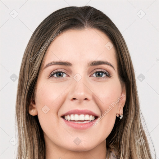 Joyful white young-adult female with long  brown hair and grey eyes