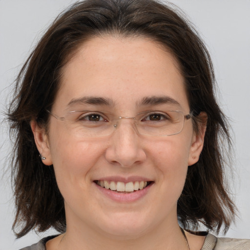 Joyful white adult female with medium  brown hair and brown eyes