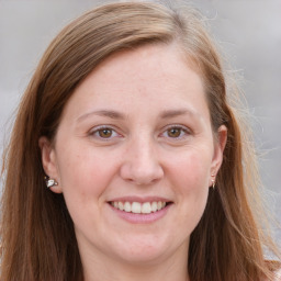 Joyful white young-adult female with long  brown hair and blue eyes