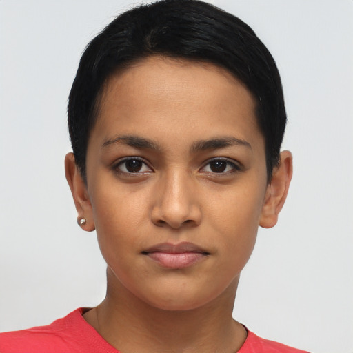 Joyful latino young-adult female with short  black hair and brown eyes