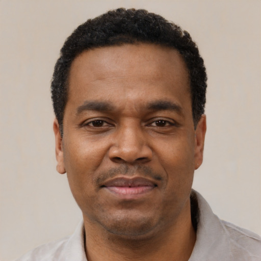 Joyful latino adult male with short  black hair and brown eyes