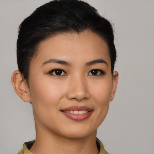 Joyful asian young-adult female with short  black hair and brown eyes