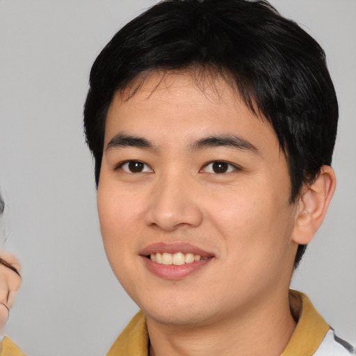 Joyful white young-adult male with medium  black hair and brown eyes