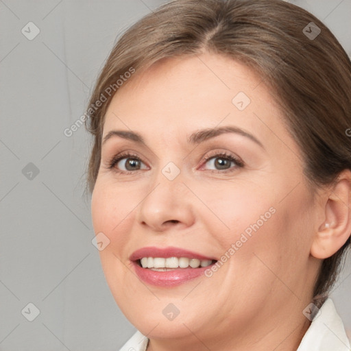 Joyful white adult female with medium  brown hair and brown eyes