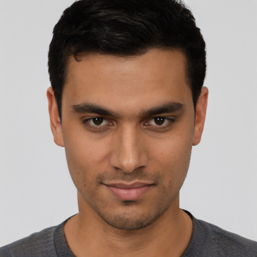 Joyful latino young-adult male with short  black hair and brown eyes