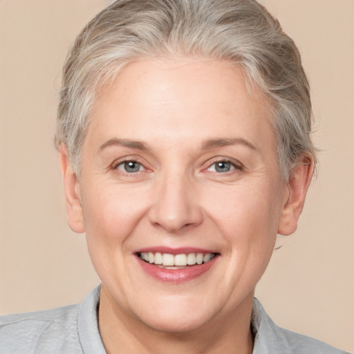 Joyful white adult female with medium  blond hair and brown eyes