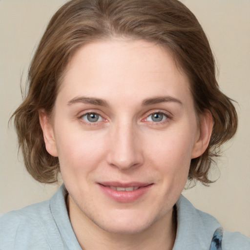 Joyful white young-adult female with medium  brown hair and blue eyes