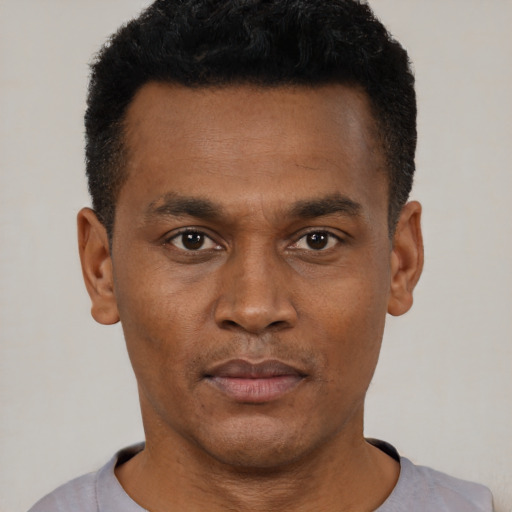 Neutral black young-adult male with short  black hair and brown eyes