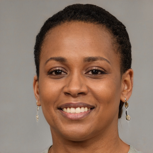 Joyful black young-adult female with short  brown hair and brown eyes