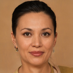 Joyful latino adult female with medium  brown hair and brown eyes